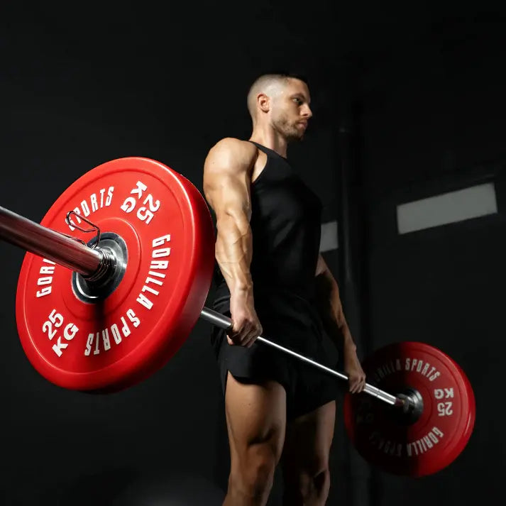 athlete doing deadlifts with barbell and 25 kg bumper plates